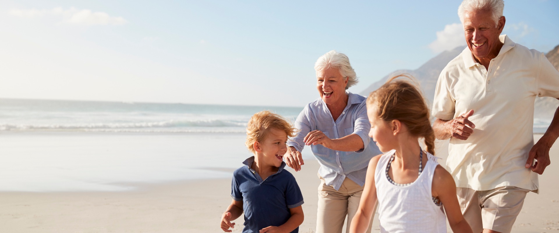 About Maitland Financial Group; picture of grandparents and grandchildren on beach